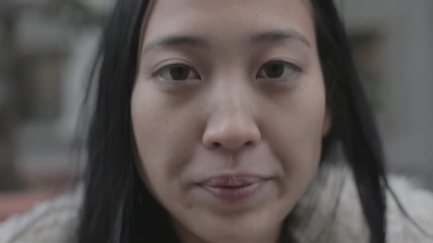 A woman is looking down before staring forward