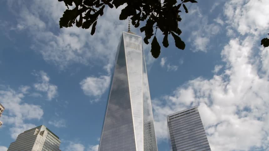 Several skyscrapers rise towards a blue sky
