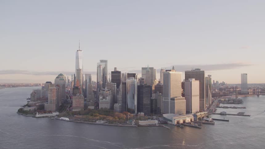 Orange haze covers horizon behind city downtown crowding peninsula