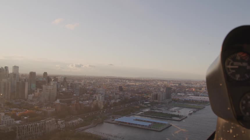 View from inside of helicopter cockpit of city skyline