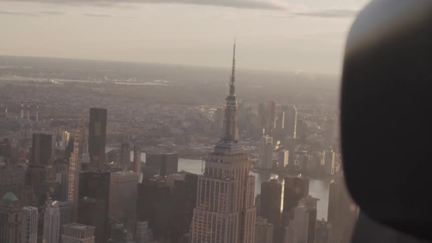 The empire state building and city seen through a window high above
