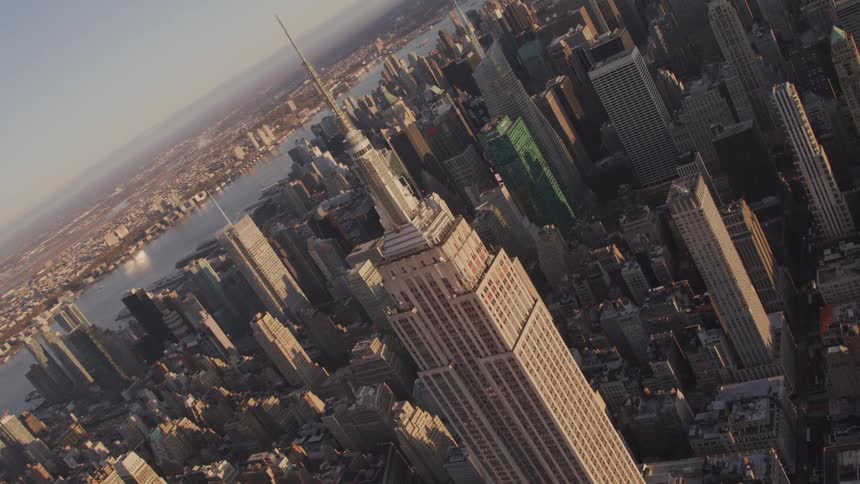 The empire state building and rooftops on a sunny day
