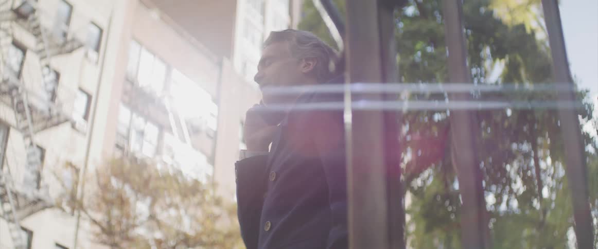 Businessman talks on the smart phone in the street