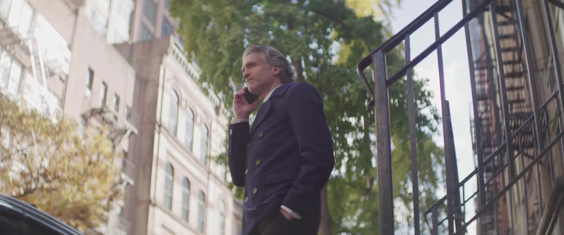 Businessman speaks on the cell phone in the city