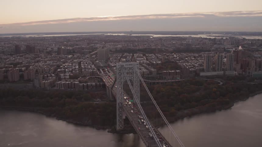 Aerial view of the manhattan bridge on the river and a long line of vehicles in a traffic jam