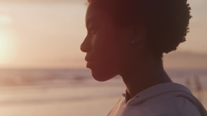 A woman stands on a beach