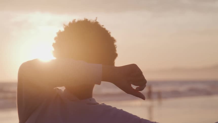 A woman is dancing on the beach
