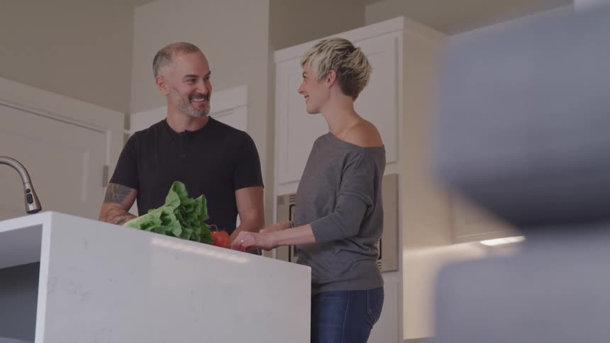 A man and woman prepare food together