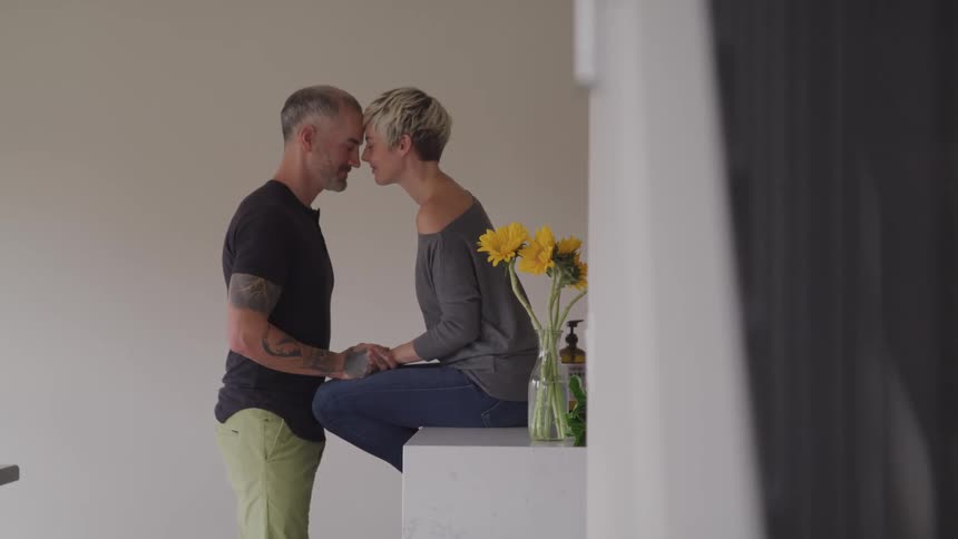 Couple touch foreheads at home