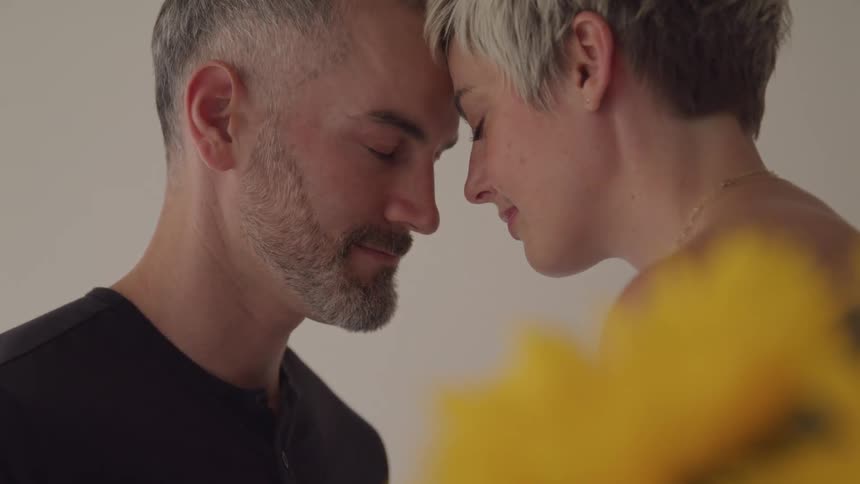 Romantic couple with eyes closed touching foreheads