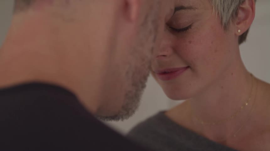 A couple lean into each other