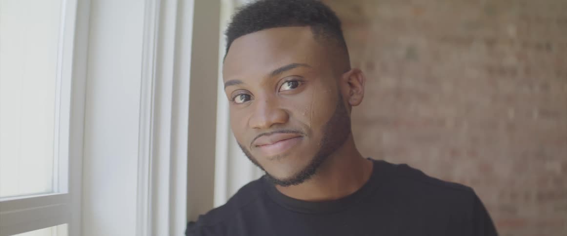 Black man turns his head to look at the camera