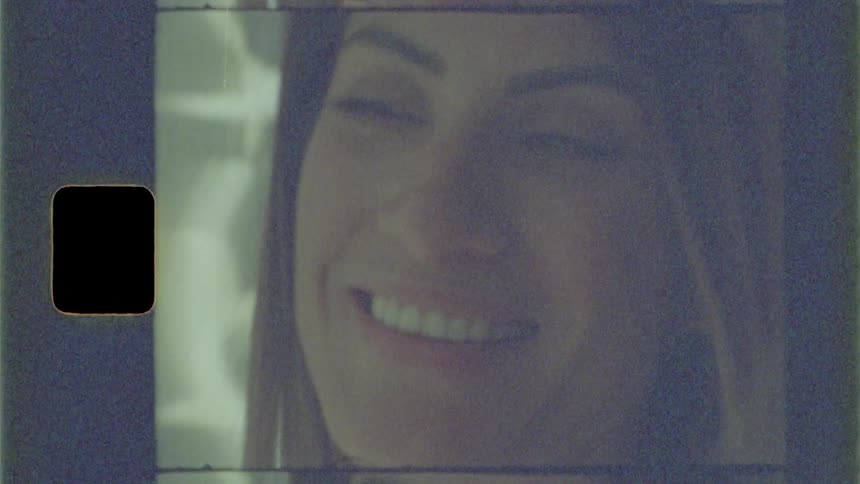 A woman is smiling and moving her head