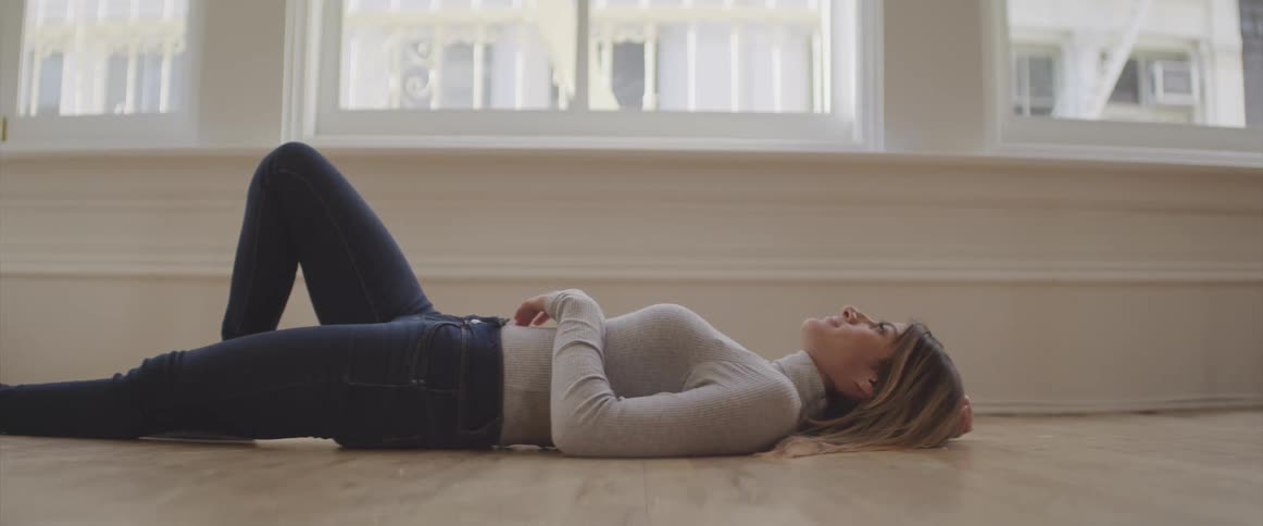 A female laying on floor