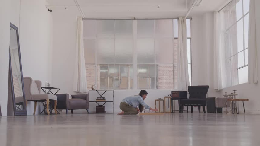 A woman painting while sitting on the floor