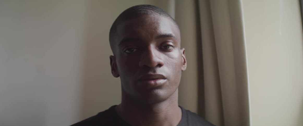 A man is staring straight ahead unblinking