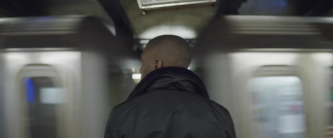 A man is waiting for the train in the subway