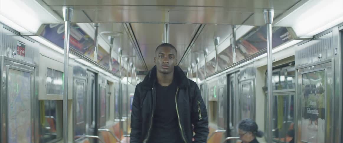 The man stands in the middle of the subway car