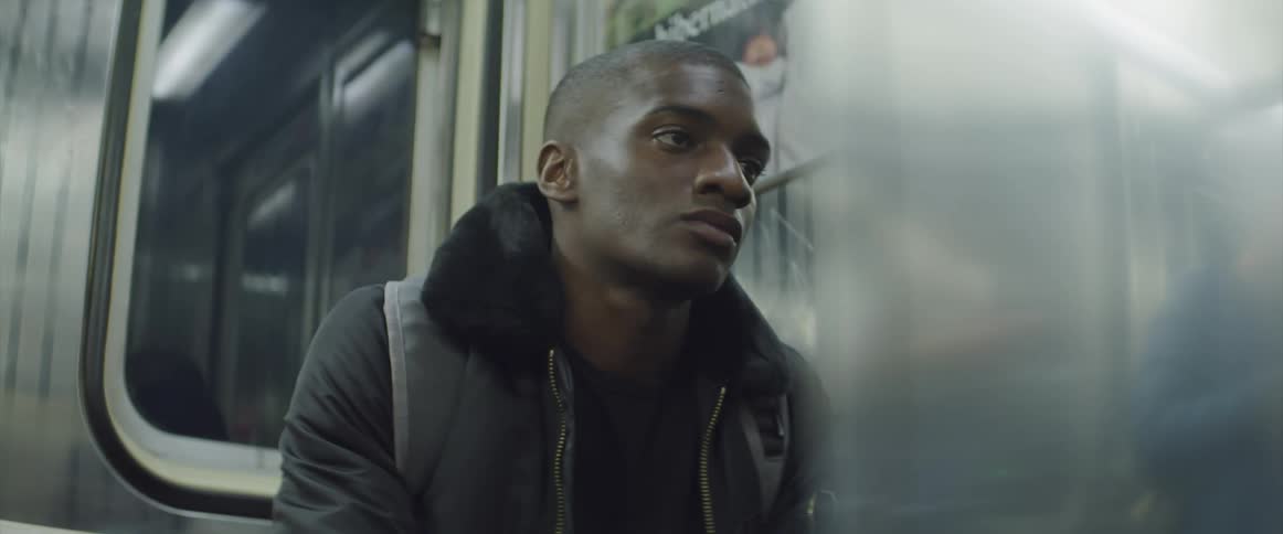 A man is bored as he sits in a moving train car