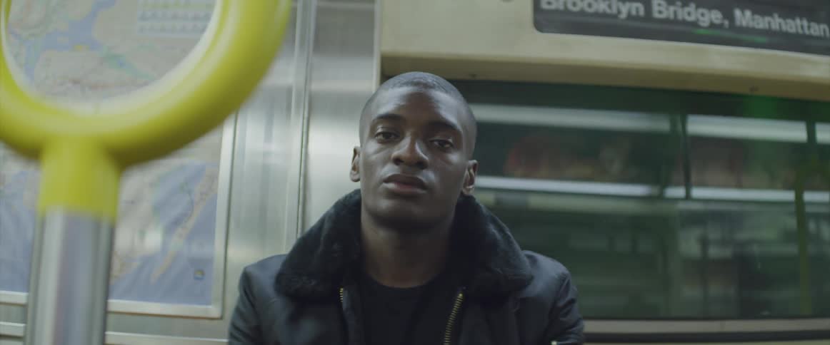 A man is riding the subway train