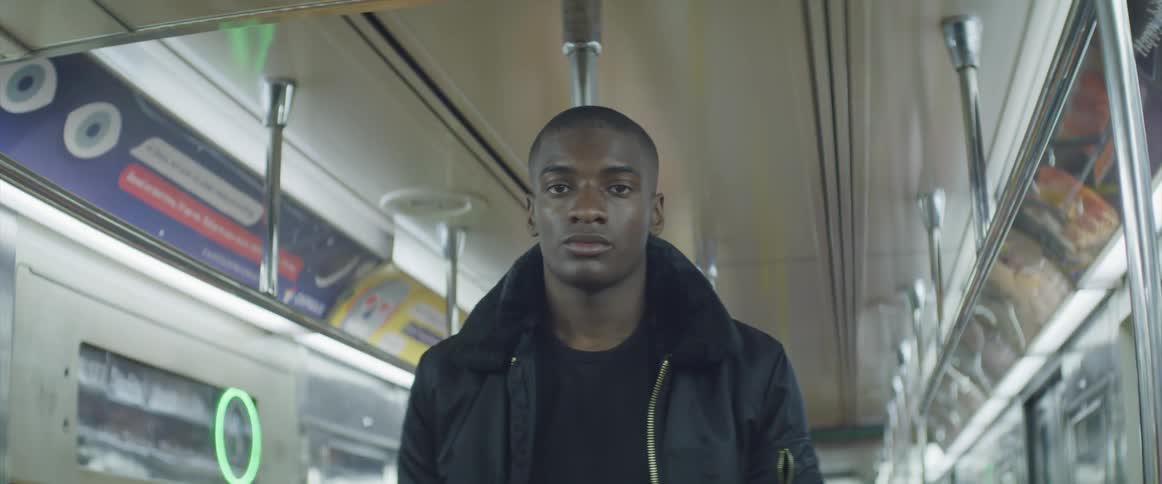 A teenager stands on a bus