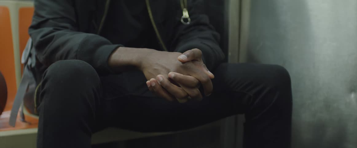 Black man sits in a train