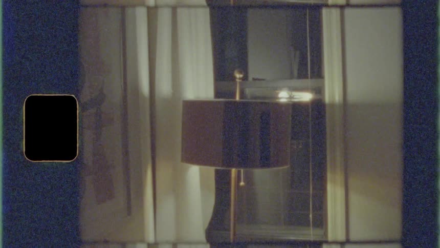 The lamp is on near the window