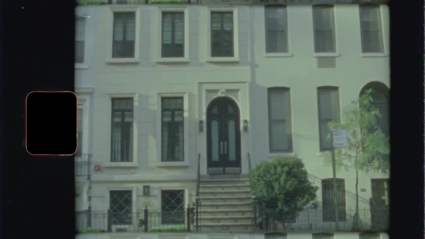 A car drives by the apartment building