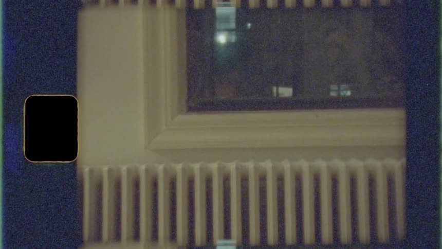 A white painted radiator sits under a window in a room