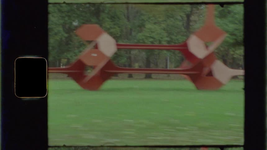 An art installation in a park with grass and trees