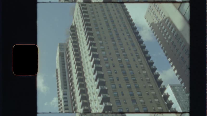 Tall apartment buildings in city downtown at day caught on film