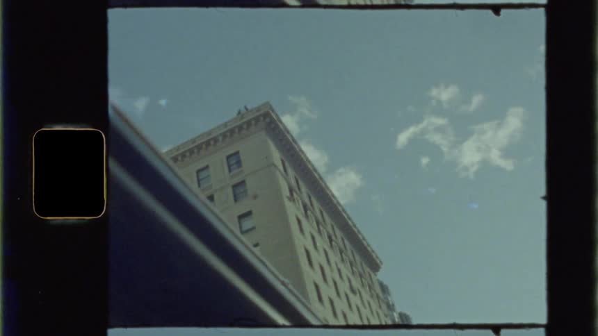 Footage of a building and clouds is displayed