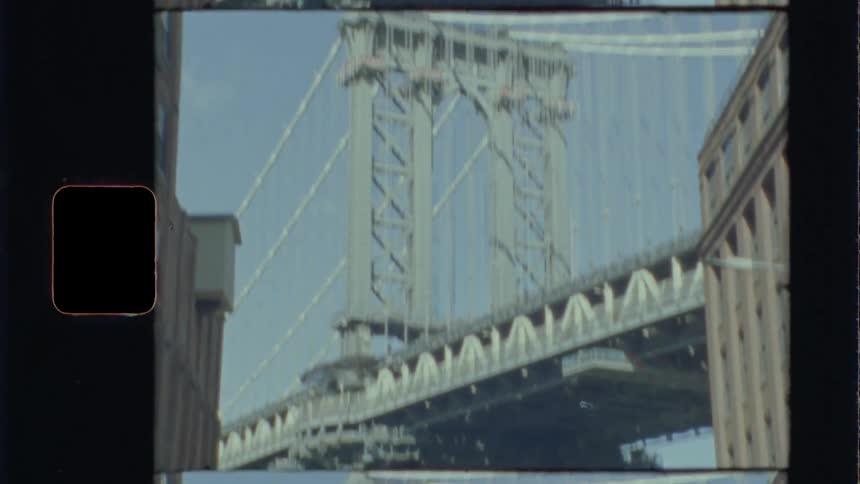 Looking up at a bridge from the city street on a bright sunny day