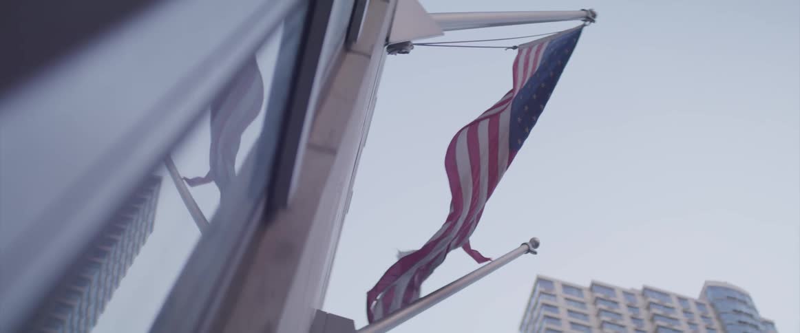Wall mounted american flag flutters in the wind