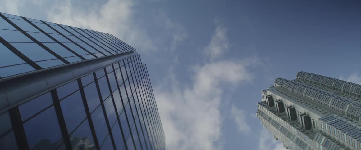 Time lapse of clouds moving across high rises in the city
