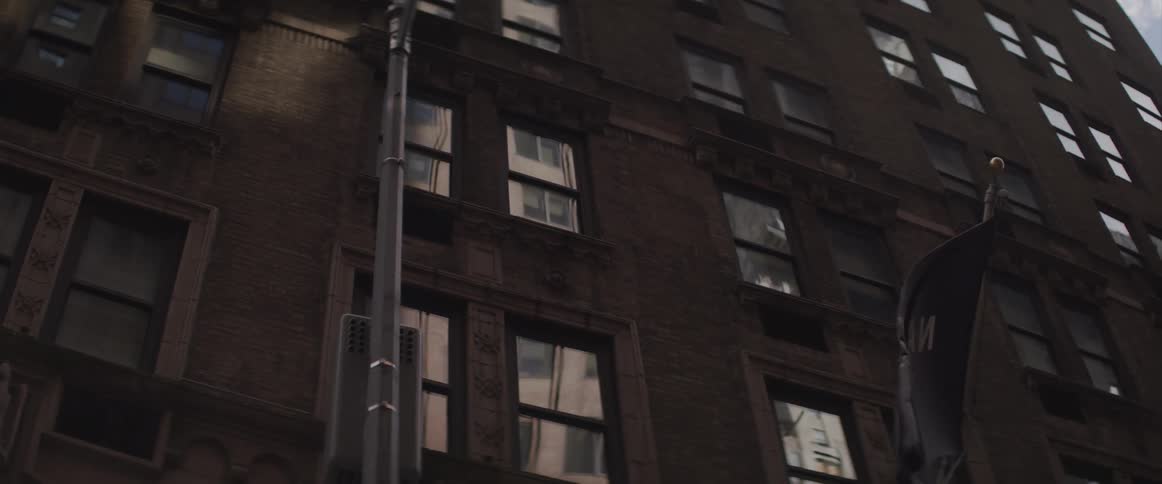 The flag blows in the wind by the building