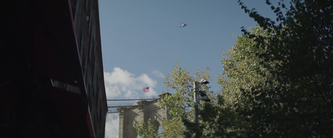 A helicopter flies in the sunny sky