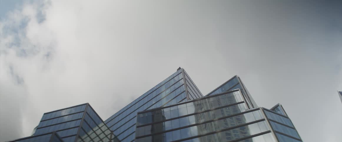 The clouds pass over the top of the building