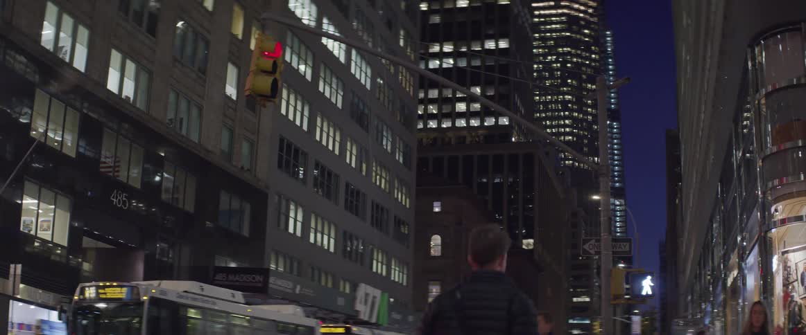 A city street with people vehicles and buildings