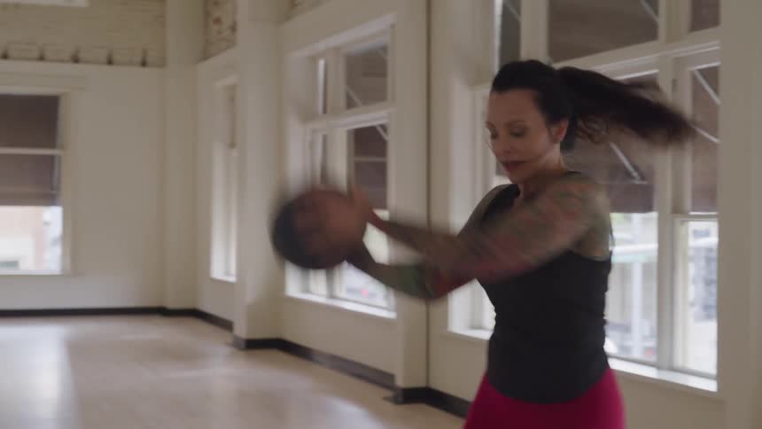 A woman exercises inside