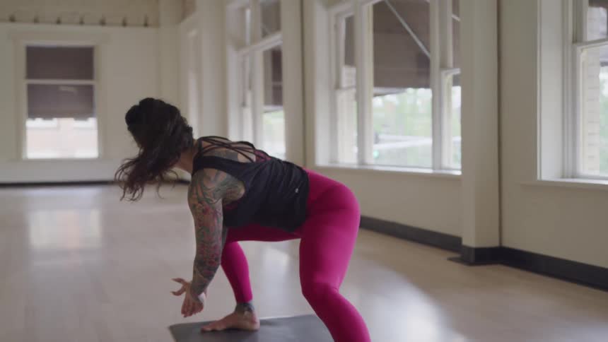 A woman practices yoga inside