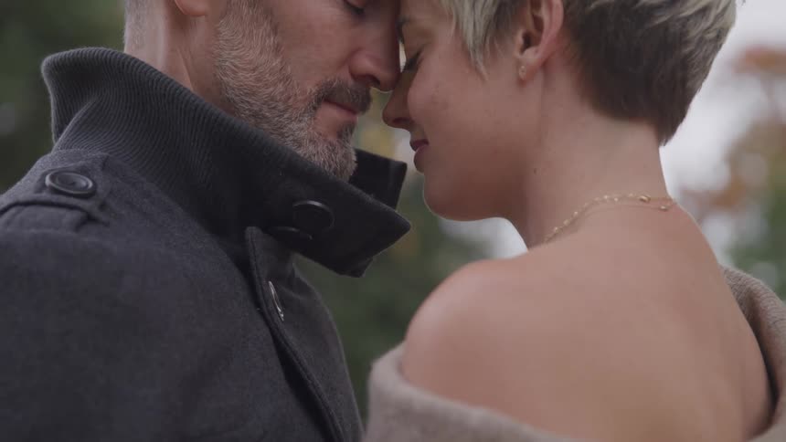 Man and woman stand face to face in the public park