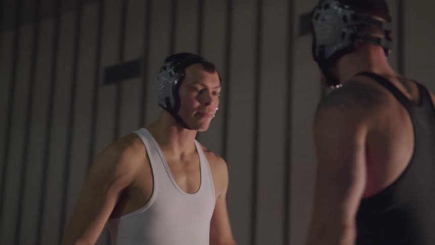 A pair of wrestlers facing each other in preparation for a match