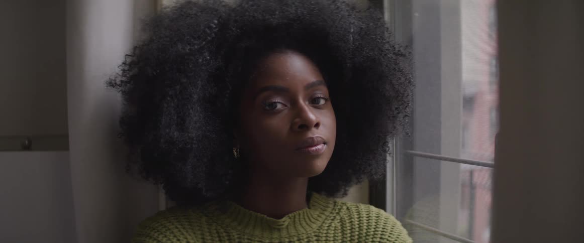 A woman sitting by the window then starts to stare