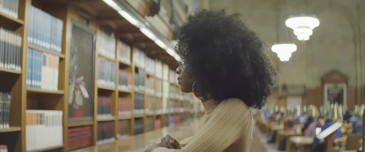 A student waits at the library counter