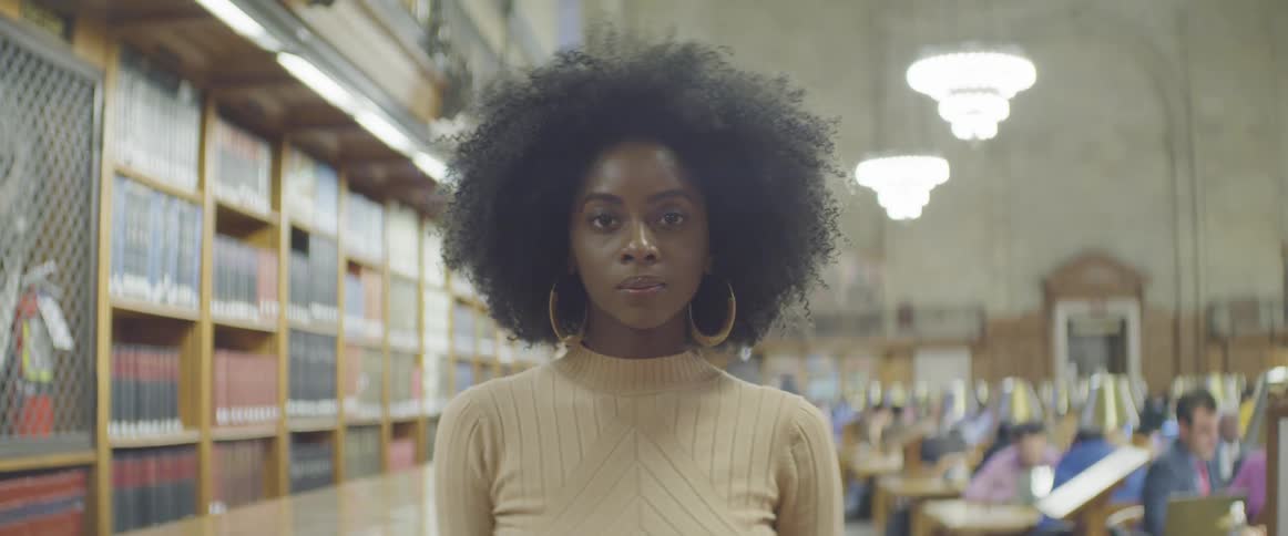 A woman stands in a library