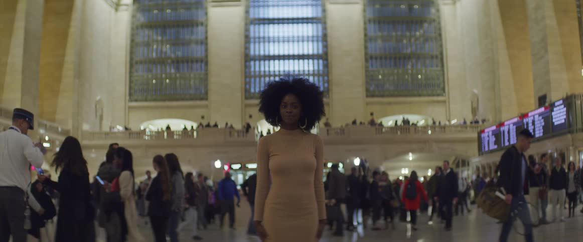 People walking around a train station