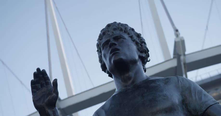 The statue sits in front of the building