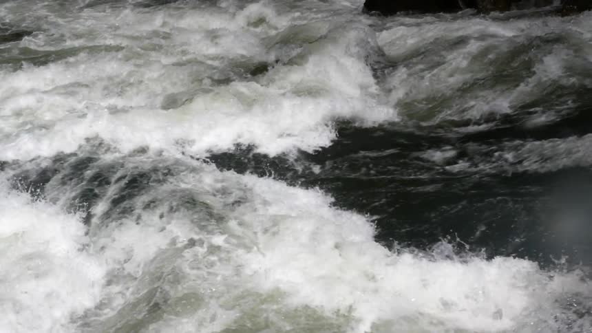 Water swirls and churns as it flows