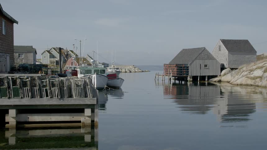 Water reflects buildings and boats lining inlet